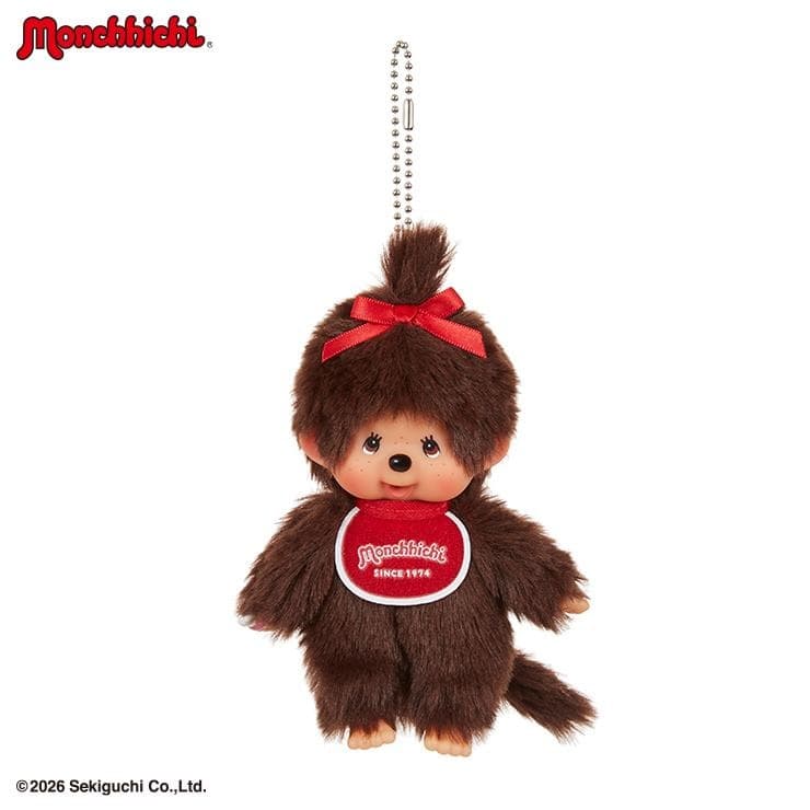 Plush Monchhichi girl keychain with a red bow and bib