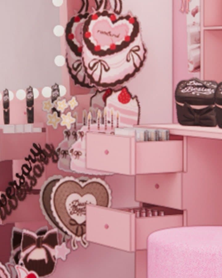 A pink vanity table with heart mirrors and a birthday cake at the rom&nd Pink Office
